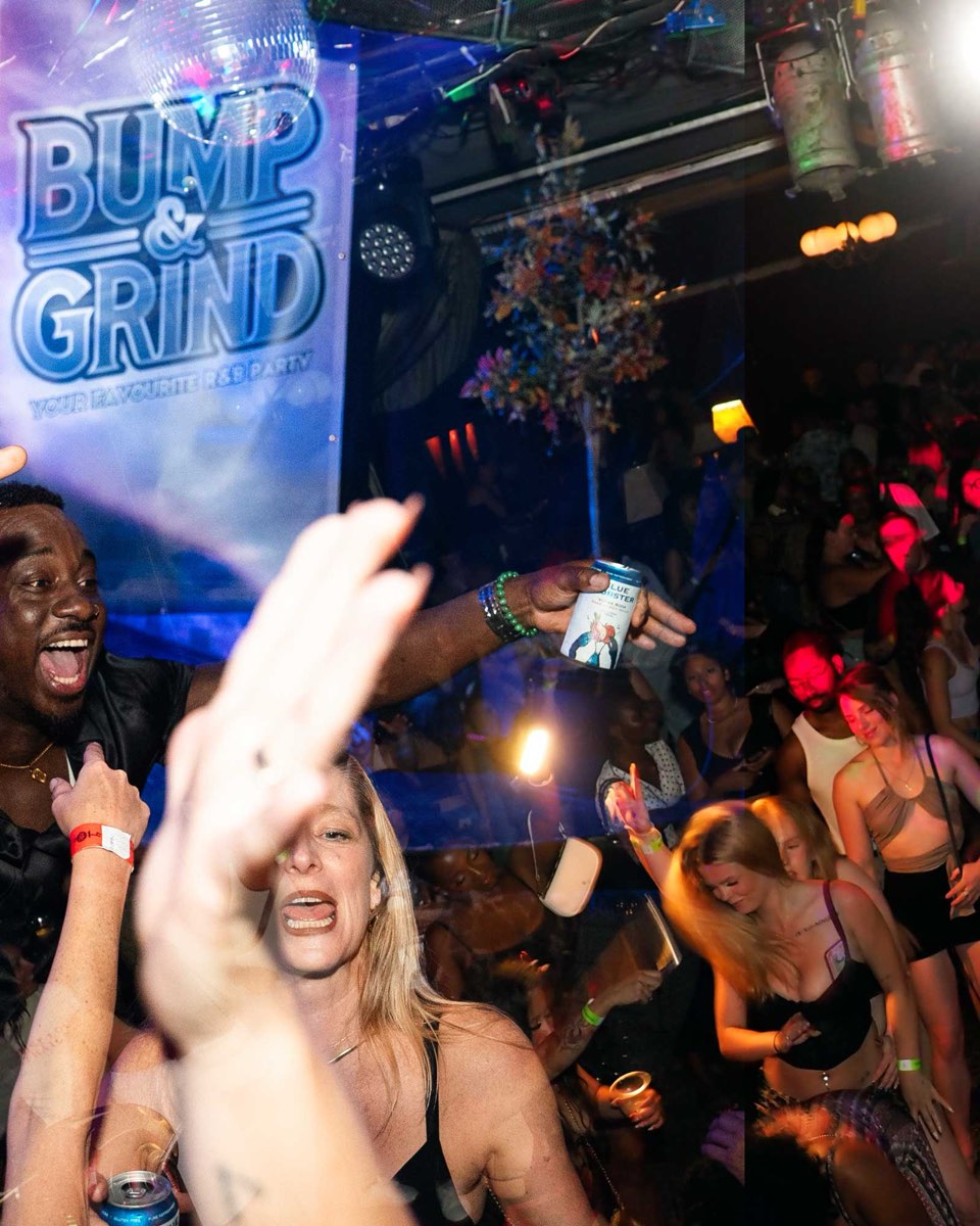 A packed Bump & Grind dance floor, crew singing along under the disco ball and club lights, the Bump & Grind banner on the wall