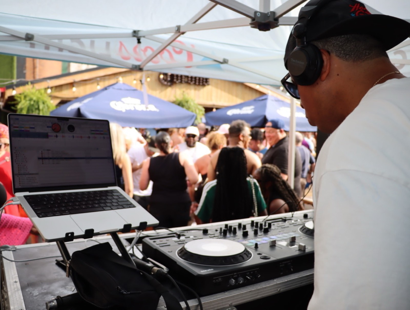 The DJ keeping the crowd moving on the patio at the day party